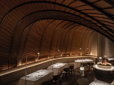 Modern restaurant interior with metal decor and arches