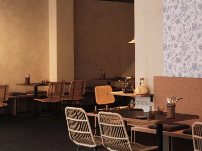 Modern cafe interior with wooden tables, woven chairs, and floral wallpaper