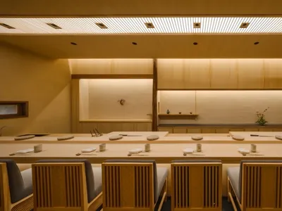 Modern restaurant interior with wooden furniture and minimalist design.