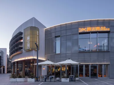 Modern restaurant with metal-cladding exterior and illuminated signage