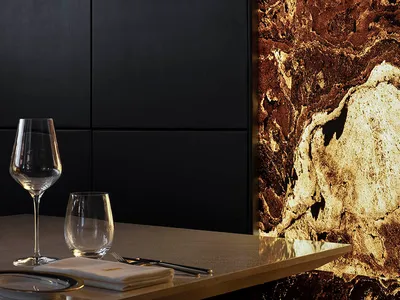 Modern restaurant interior with marble walls and minimalist design.