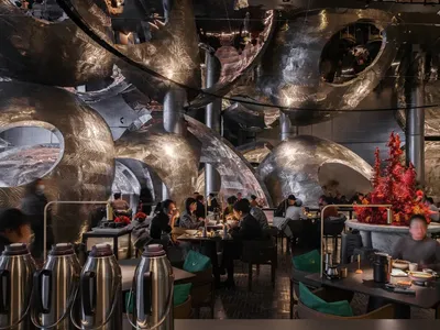 Modern restaurant interior with metallic texture and circular structures