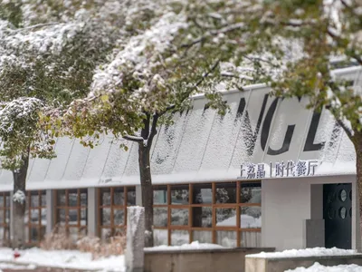 A modern restaurant exterior covered in snow.