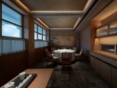 A modern restaurant interior featuring dark wooden elements and stone flooring.