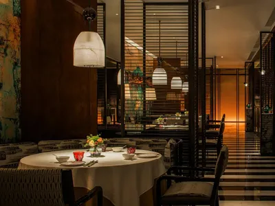 A modern, industrial-themed restaurant with metal, glass, and wooden elements