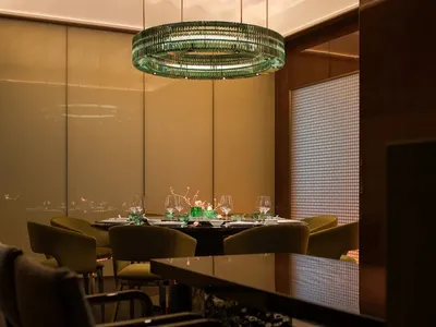 A modern restaurant interior with a glass ceiling and elegant decor.