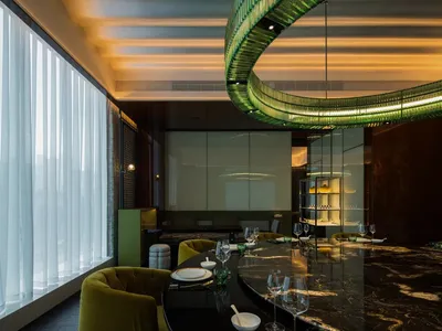 Modern restaurant interior with marble and glass materials.