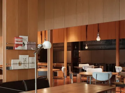 Modern interior design of a restaurant cafe with wooden tables and chairs, natural lighting, and minimalist decor.
