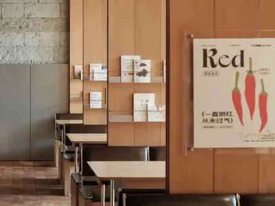 Interior of a modern restaurant featuring wooden paneling and concrete walls.