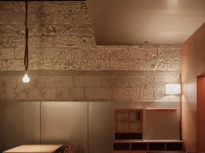 Modern industrial restaurant interior with brick walls, wooden furniture, and metal accents.