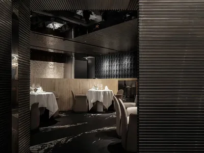 Modern restaurant interior featuring a dark, metallic design.