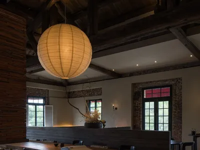 An industrial-style restaurant interior with a wooden table setting.
