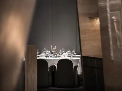 Modern restaurant interior with glass accents and contemporary furniture.