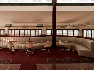 A spacious, industrial-style hospitality design with a mix of leather, metal, and glass materials.
