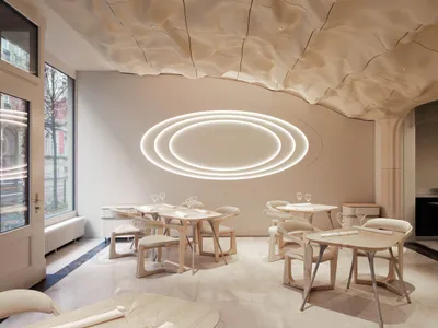 A modern restaurant dining room with white walls, circular lighting fixtures, and wooden tables and chairs.