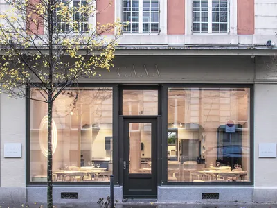A modern restaurant storefront with glass windows and a sleek design