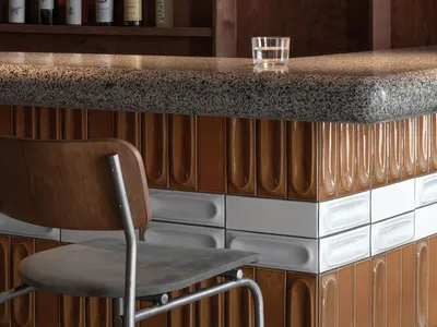 Industrial-style bar counter made of marble with a textured surface.