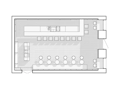 A floor plan of a coffee shop with seating areas, a counter, and a kitchen area.