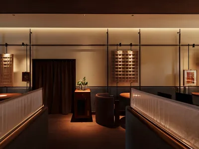 Interior view of a Japanese cuisine restaurant with wooden materials and minimalist decor.