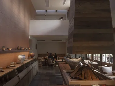 Modern restaurant interior with wooden elements and seating area