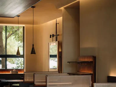 Modern restaurant interior featuring concrete materials and contemporary design elements.