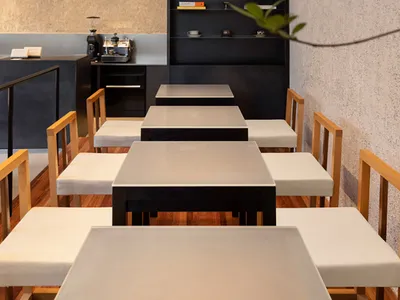 Modern restaurant interior with minimalist design and natural elements.