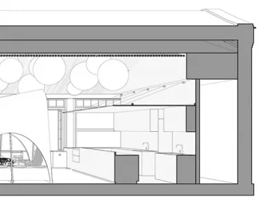 An industrial-style restaurant with metal arches, glass panels, and brick accents