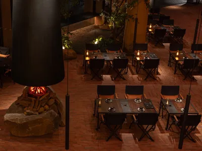Industrial restaurant with brick walls and folding chairs.