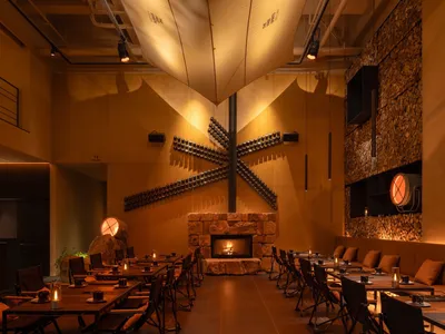An industrial-style restaurant with metal, wood, and stone elements.