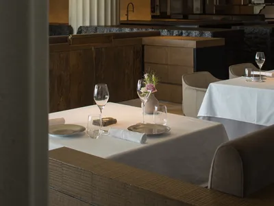 Modern restaurant interior with wood, stone, and metal details