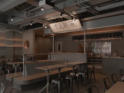 現代工業風餐廳內部，混凝土牆面與座位區。