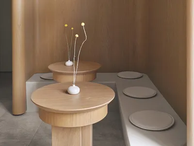Modern designed restaurant booth seating with concrete flooring and wooden tables and benches.