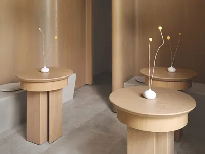 A modern restaurant interior with wooden furniture and minimalist design.