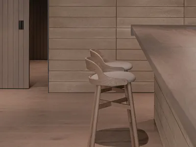 現代工業風廚房吧台，搭配木質吧椅與混凝土檯面。