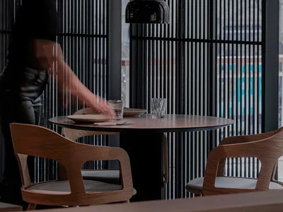 A modern, well-lit restaurant setting with contemporary furniture and lighting fixtures.