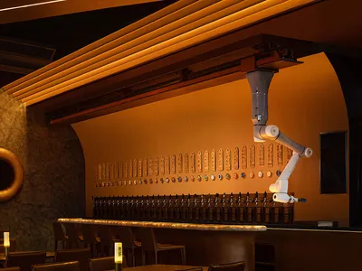 An industrial-themed restaurant bar featuring warm lighting and a sleek, modern design.