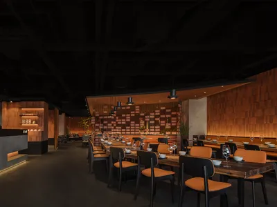 Modern restaurant interior with wooden elements and contemporary decor.