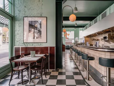 Modern cafe interior with a tiled counter featuring black and white tiles.