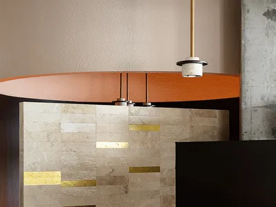 A modern restaurant interior featuring marble accents and minimalist design.