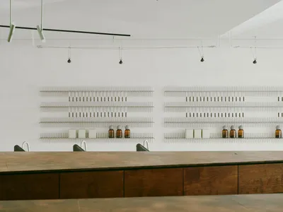 Modern restaurant interior with wooden tables and concrete walls