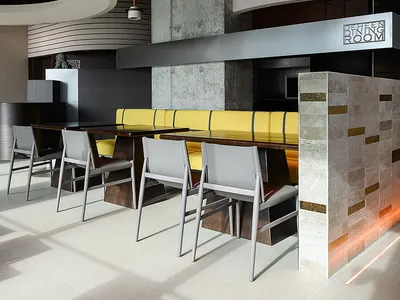 Modern restaurant interior with concrete, wood, and metal materials