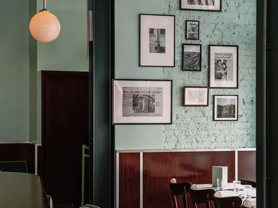 Modern restaurant interior featuring concrete, wood, and brick elements.