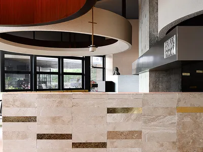 Modern restaurant interior featuring concrete and marble materials.