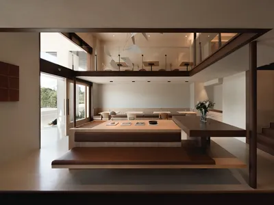 A modern restaurant interior with a wooden dining area and seating.
