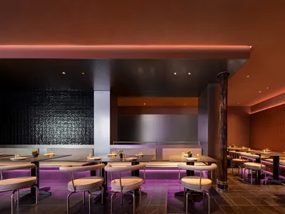 A modern, metallic-finished restaurant interior with illuminated lights.