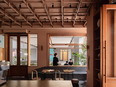 Modern restaurant interior featuring wooden elements and seating