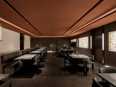 Modern restaurant interior featuring marble countertops, leather seating, and wooden furniture.