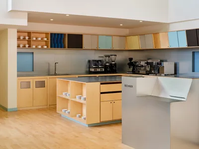 A modern kitchen with wooden cabinets and stainless steel appliances