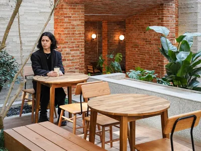 Industrial-style restaurant exterior with brick walls and white signage