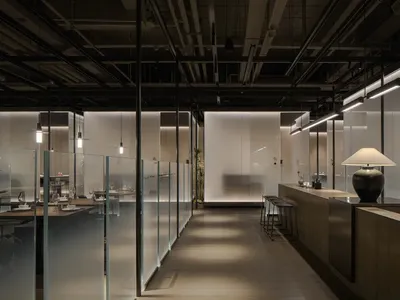 Industrial-themed restaurant featuring glass, steel, and wooden elements